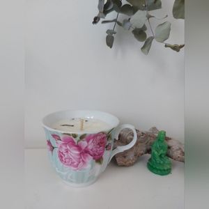 Candle in a pretty tea cup with rose motifs, vintage.